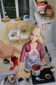 Cannibal barbie in kitchen over bloody doll