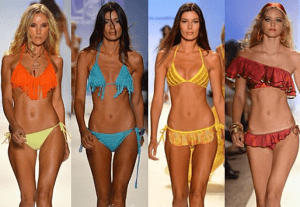 Ladies on the runway in their bright swim suits