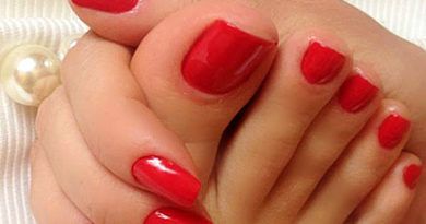 Bright red fingernails and toes close-up