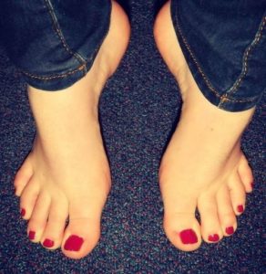 Toes pointed down in red toenail polish