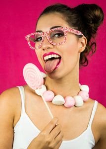 Big pink lollipop and candy necklace on this brunette