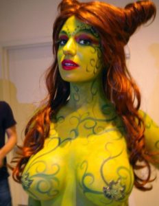 Sexy redhead in exquisite yellow plantlike body paint